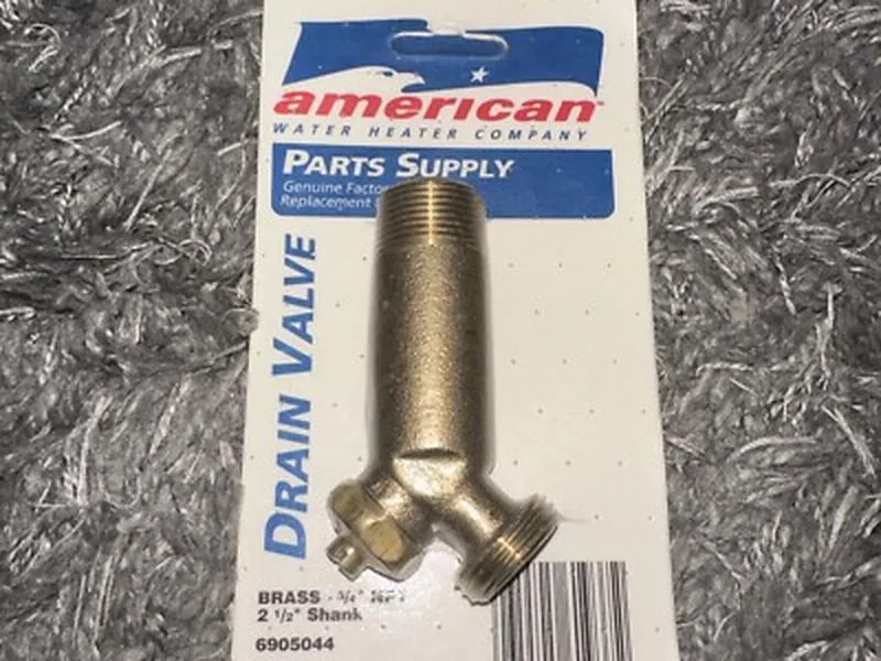 Plumber installing a brass drain valve on a Tempe AZ water heater