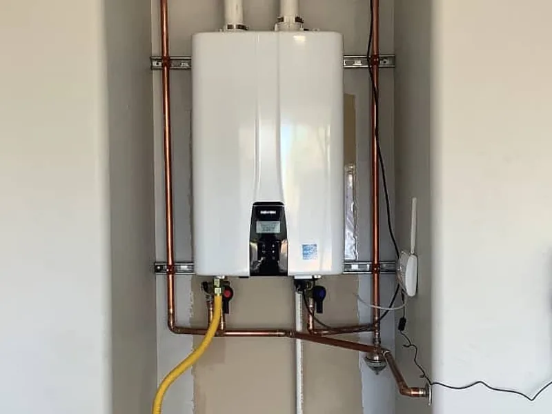 Technician diagnosing a leaking tankless water heater in Chandler, AZ 85225