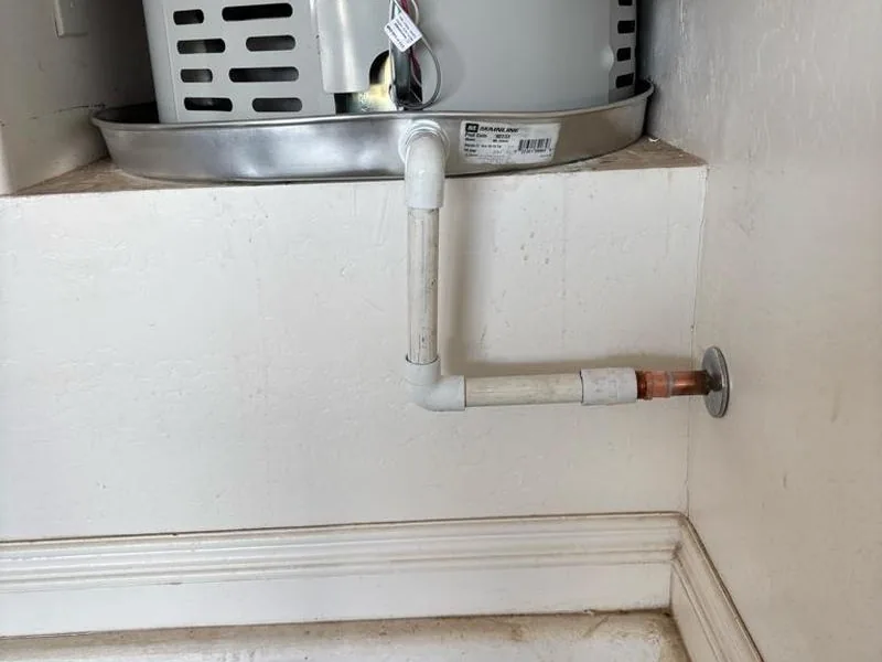 Water heater sitting centered in a properly sized drain pan in a Florence attic