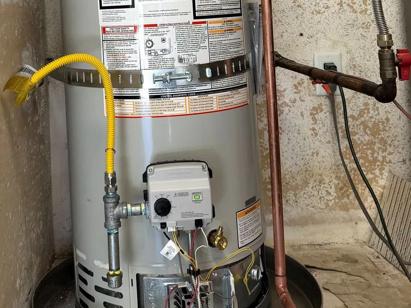 New aluminum drain pan installed under a tank water heater in a Fountain Hills home