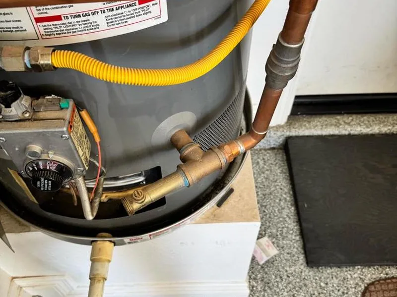 New aluminum drain pan installed under a tank water heater in a Mesa home