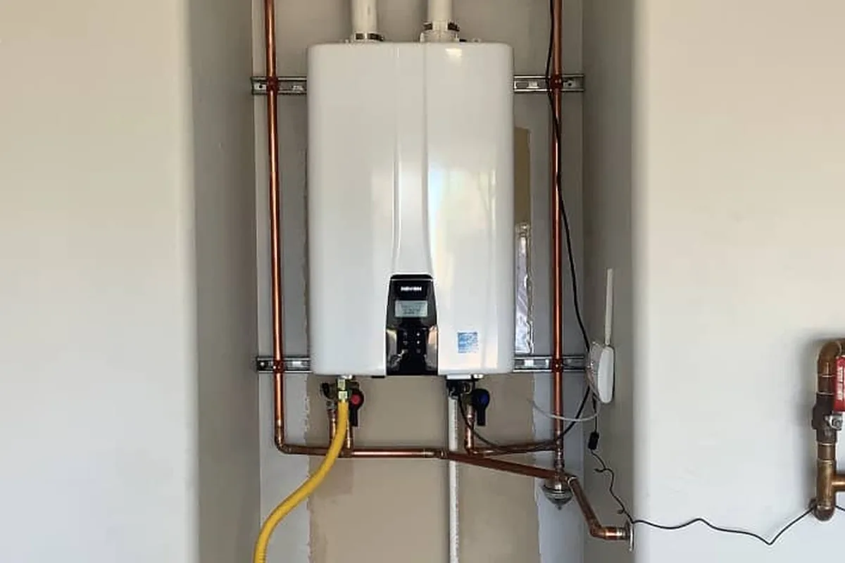 Technician servicing a leaking tankless water heater in Apache Junction Arizona